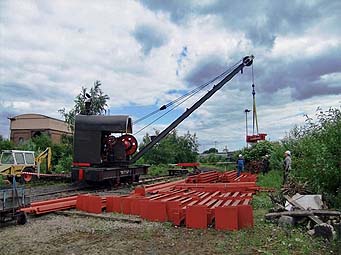 Didcot's small steam crane assists in laying the last length of track on the shed site - October 2009. 